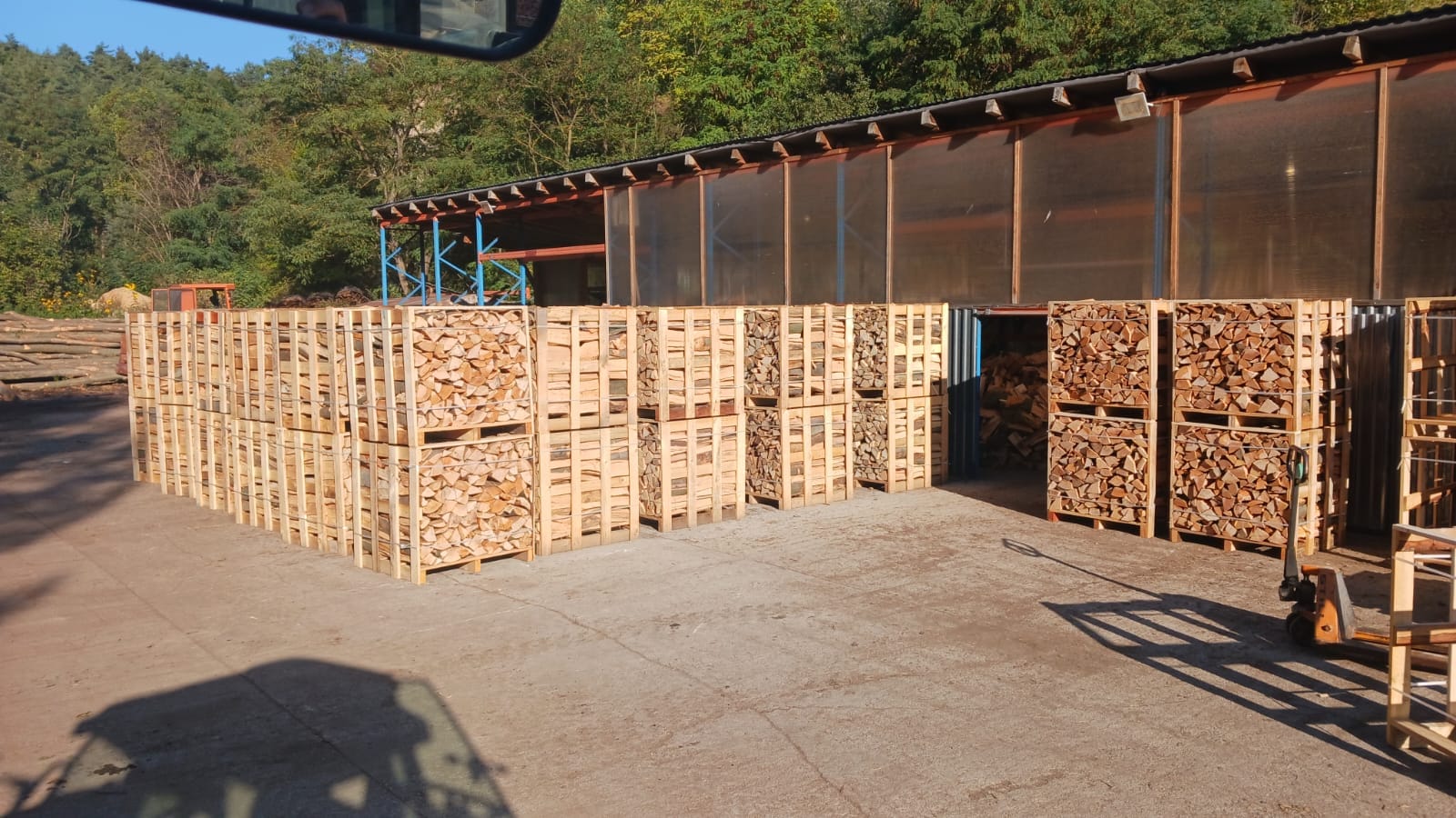 Palivové dřevo v klecích pod přístřeškem MMLES